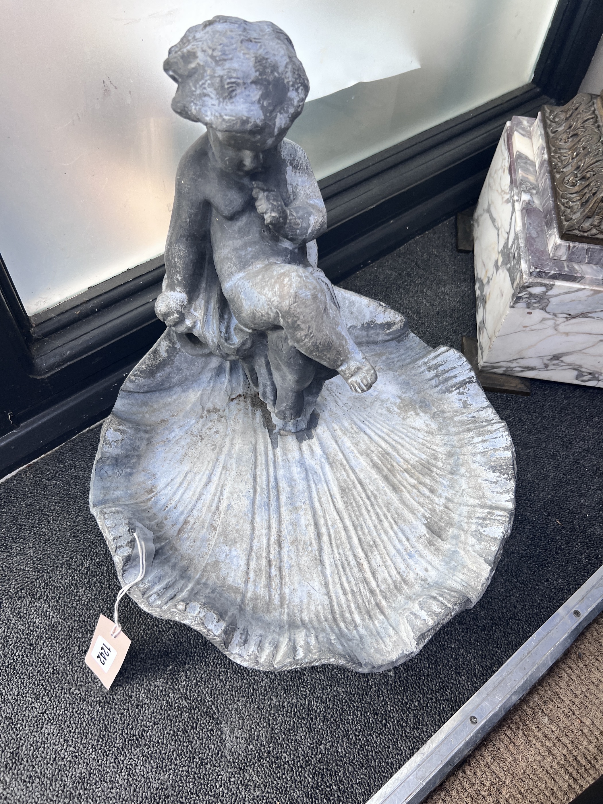 A lead putti and scallop shell bird bath, height 42cm